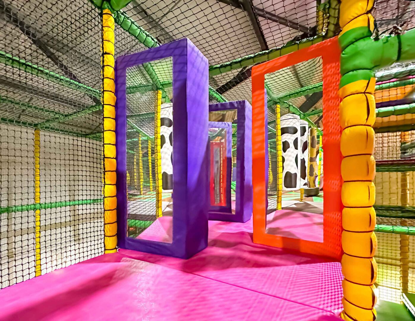 Purple and orange bumper mirrors featured at Cannon Hall Farm's indoor softplay area designed by Play Creations