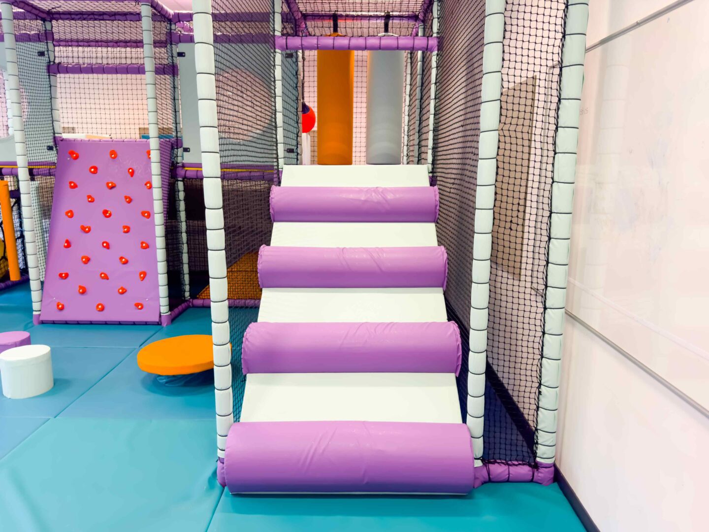Purple and white log ramp at Trinty School's indoor softplay.