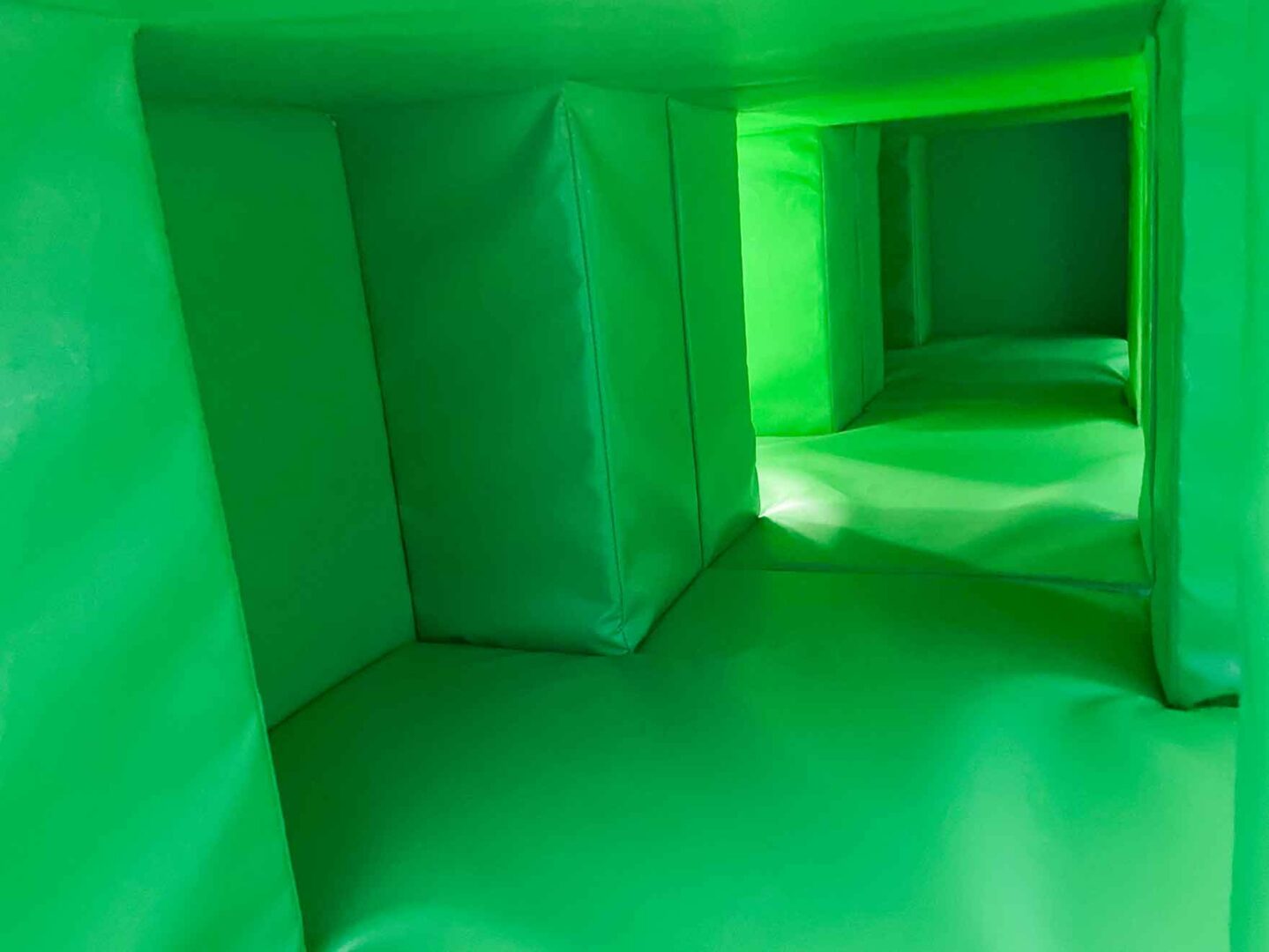 Inside the green softplay blocks in the movement area at St Giles School.