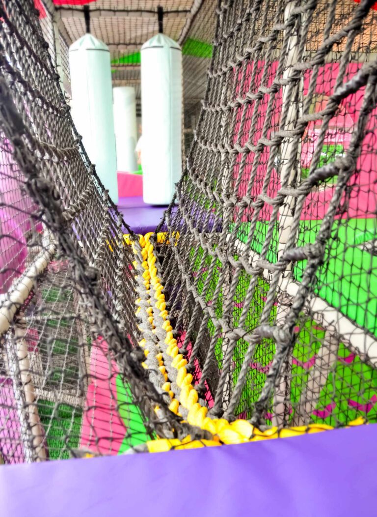 This is the black and yellow rope bridge at Fun Factorys indoor softplay area. There are also 2 vertical crash bags in the background which are white.