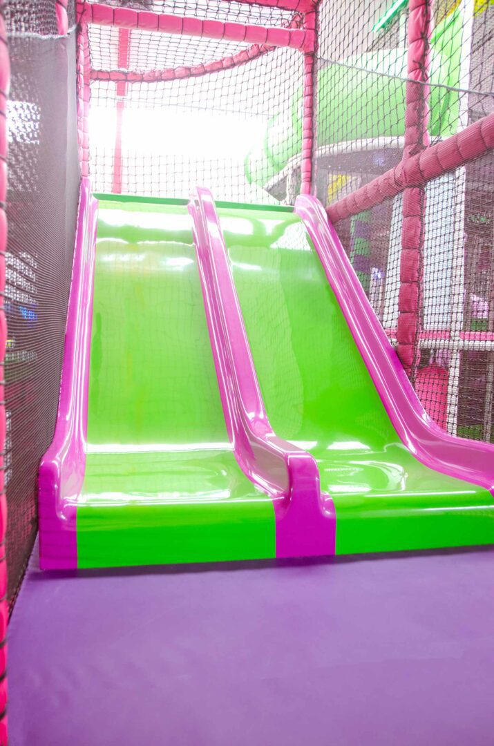 This is the green and purple slide found in the toddler area at Fun Factory. The slide has 2 lanes.