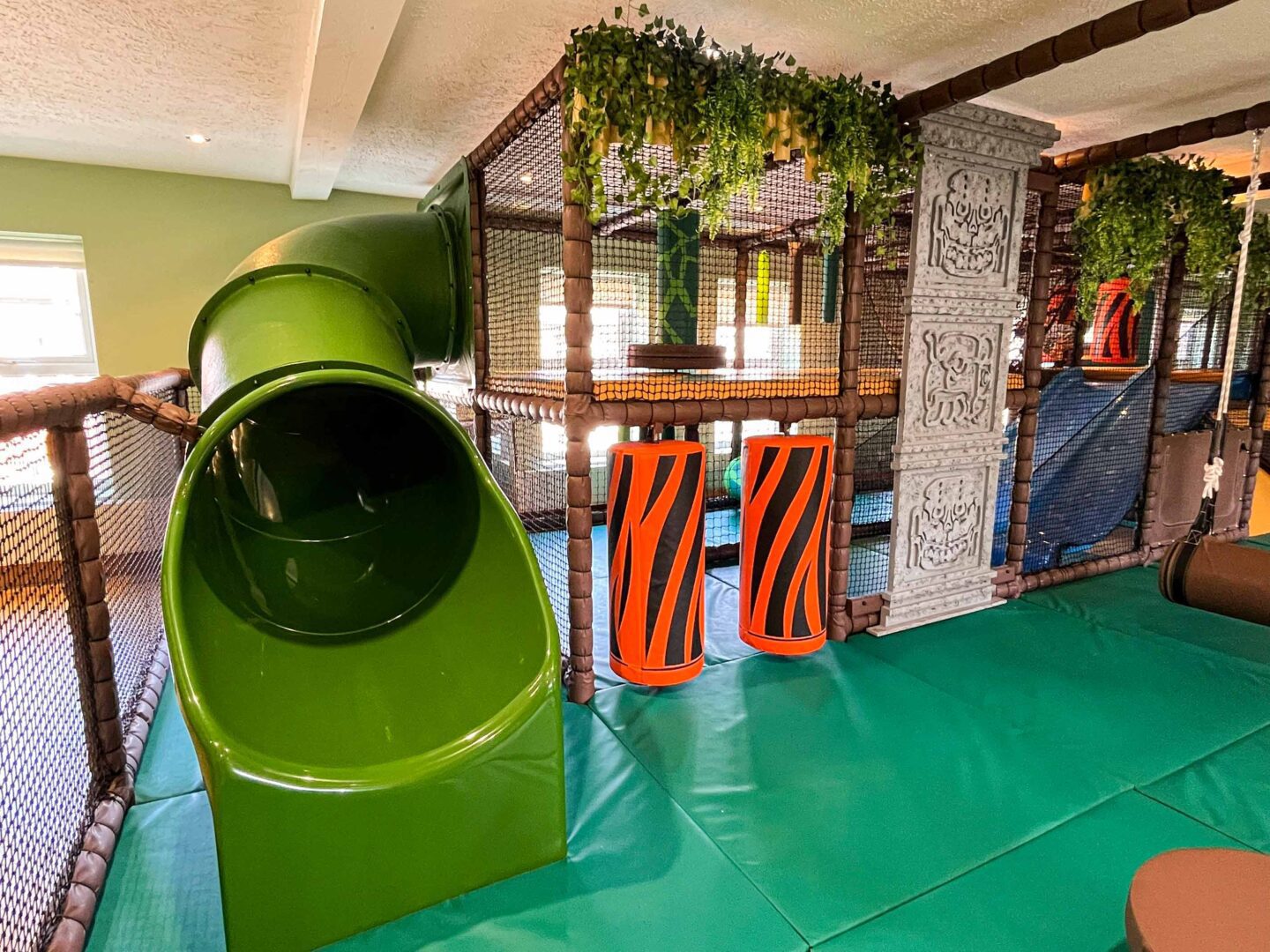 Hunter's Quest's main area containing a fiberglass slide and vertical rollers. This softplay can be found in Magherafelt and was designed by Play Creations Ltd.
