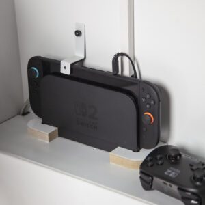 close-up of a nintendo switch 2 in a secure holder in the Playhub entertainment console.